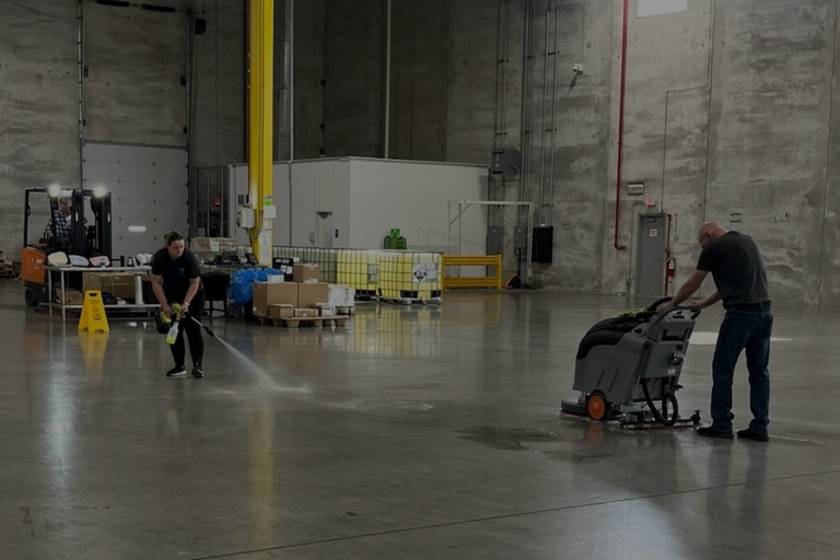 Technician operating industrial floor buffer